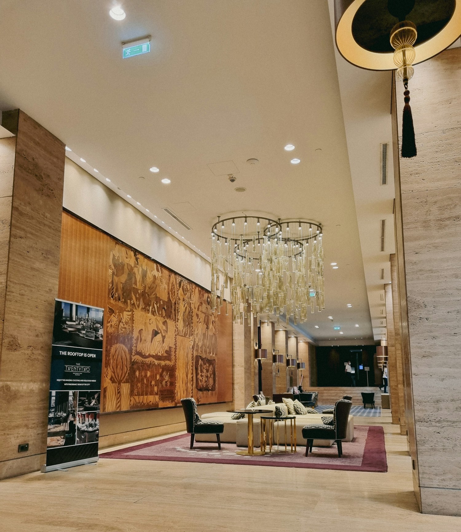 Illustrative hotel lobby with warm stone and decorative lighting